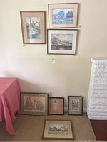 6 framed artworks displayed on and above carpet, showing variety in style and size