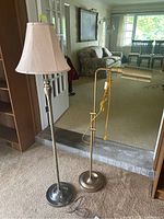 Image showing both floor lamps side by side with a view of their base and shade or light head.