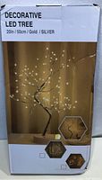 Photo of the product box showing it is a decorative 20 inch LED tree available in gold or silver with USB power.