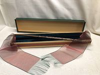 Full view of Hermione Granger wand in box with sheer maroon scarf
