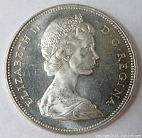 Obverse side of the 1966 Canadian silver dollar coin showing Queen Elizabeth II profile and inscription.