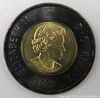 Close-up photo of the obverse side of a 2022 Canadian $2 Black Toonie coin showing Queen Elizabeth II's effigy, inscriptions ELIZABETH II, D G REGINA, and year 2022 on a black outer ring and gold center.