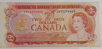 Front side of 1974 Canadian two dollar bill showing Queen Elizabeth II portrait, serial numbers, and security features.