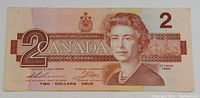 Front side of the 1986 Canadian $2 banknote showing Queen Elizabeth II and denomination details.