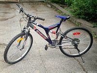 Full side view of the blue Dyno Void mountain bike showing frame, tires, handlebars, and seat.