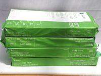 Four packs of Grand & Toy premium copy paper stacked together, showing packaging and paper size details.