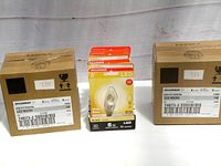 Two Sylvania branded boxes each containing six LED micro bulbs in retail blister packaging. Boxes are marked with product codes and specifications showing 5W and 1W LED bulbs rated at 120V.