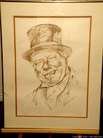 Full view of framed W C Fields print by Harold Lloyd Bates with a visible white and brown mat.