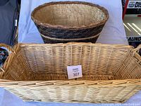 Top view showing round dark patterned basket and rectangular light wicker basket inside each other