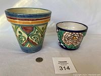 Photo showing two Mexican ceramic flower pots side by side with a coin for scale.