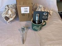 Lot items shown together: crystal golf tee, green mug, and golf tool gift set with box