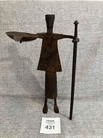 Front view of a medieval metal soldier ashtray showing the full figure, standing on two feet with a staff in one hand and an ashtray holder in the other.