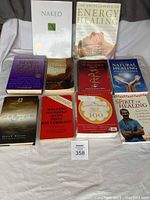 Lot of 10 natural healing and health-related books arranged on a white sheet.