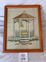 Full view of framed needlepoint gazebo artwork