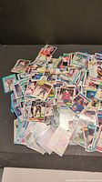 Top view showing a large pile of mixed hockey cards with colorful borders and varied player images.