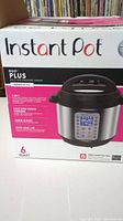 Box front showing Instant Pot Duo Plus 6 quart pressure cooker with serving size up to 6 people and image of the cooker.