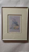 Framed watercolor artwork titled 'The Seal' depicting two seals and indigenous canoe imagery