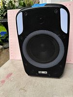 Front view of Altec Lansing portable speaker with metal grille and white accents.