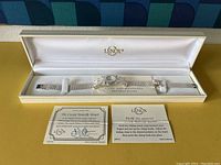 Watch displayed new in original box with Lenox branding, including care and adjustment instruction cards.