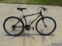 Side profile photo of a black Diamondback Apex mountain bike with 21-speed gears and knobby tires.