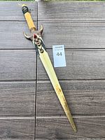 Full view of the collectible cutting tool showing the blade cover and handle with Native American themed carvings.