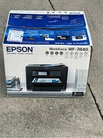 Box of Epson Workforce WF-7840 printer showing branding and model number on packaging.