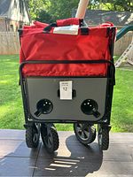 Rear view showing black metal base with two cupholders and front folding wheels.