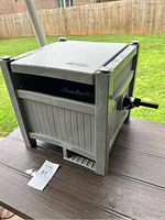 Side view of the hose reel showing plastic housing, crank handle and general condition.