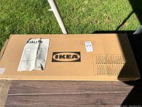 Cardboard box packaging of IKEA desk FJÄLLBO with IKEA logo and label.