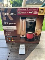 Front of the Keurig K-Supreme coffee maker box showing the product and bonus offer.