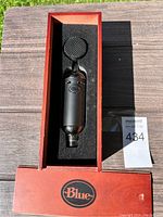 Blue professional microphone in original red box with foam cutout