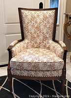 Front view of armchair showing overall condition, upholstery and frame