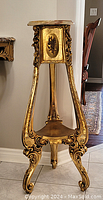 Front view of gilt wood stand with round marble top