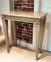 Front view of the marble top side table showing rectangular marble top on fluted legs with gold accents
