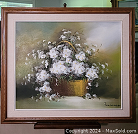 Frontal view of the oil painting showing the full bouquet of white flowers in a basket against a green background with artist signature in bottom right corner.