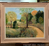 Full view of framed oil painting showing autumn rural landscape with fence and dirt road