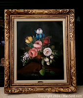 Frontal view of framed oil on canvas floral still life painting.