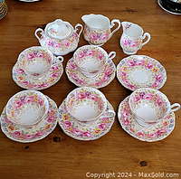 Full set view showing 5 cups and saucers with matching sugar bowl and creamer
