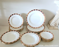 Full view of all stacks showing four groupings of plates and bowls with patterned rims