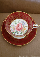 Top view of teacup inside the saucer showing floral design and gold crackle pattern