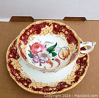 Top view of teacup showing floral interior and burgundy gold border