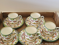 Five Wedgwood demitasse cups with matching saucers arranged in a cardboard box, showing the full lot.