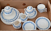 Overall view of set including sugar bowl, creamers, cups, plates, and saucers in a cardboard box
