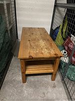 Top view of wood coffee table showing surface wear and natural wood grain.