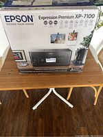 Box of Epson Expression Premium XP-7100 printer showing product branding and key features on the packaging.
