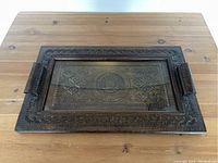 Top-down view of the rectangular hand carved wooden tray showing detailed geometric and floral carvings and side handles.