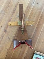 Top-down view of wooden stereoscope viewer showing handle and opening for slides.