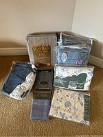 Photo showing six packaged bedding items including Egyptian Comfort 1200 queen sheet set, floral double size fitted sheet, gray textured pillowcases, and other sets.