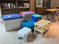 Photo showing all items in the lot including large Rubbermaid bins, smaller Sterilite bins, white plastic stool, and beige shoe rack.
