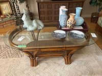 Full top view of oval glass tabletop with decorative items